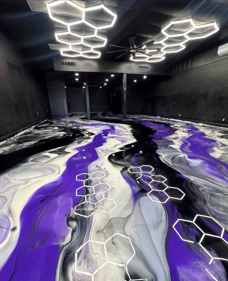JMC Epoxy installer on stunning purple, black and white metallic epoxy floor with hexagon accents